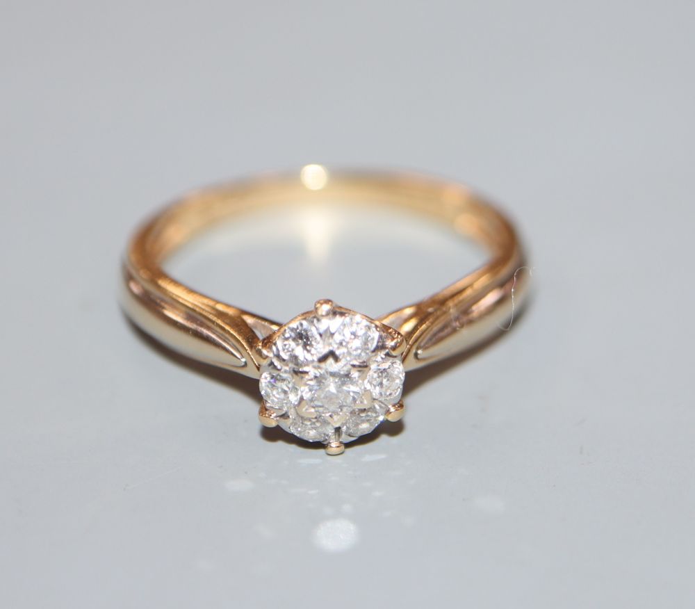 A modern 18ct gold and diamond cluster ring, size M, gross 2.6 grams.